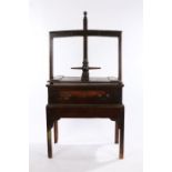 19th Century oak and elm clothes press, the screw thread top above the turned handles and press