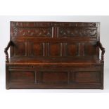 Charles II oak box-seat settle, Yorkshire, circa 1670, the back having a stylized flowering-vine