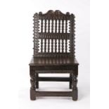 Rare Charles I oak low back stool, circa 1640, the scroll arching top rail above a series of
