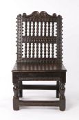 Rare Charles I oak low back stool, circa 1640, the scroll arching top rail above a series of