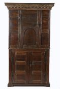 17th Century and later cupboard, the cornice above a single cupboard door and scroll carved pediment