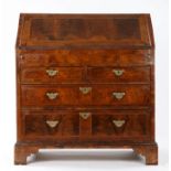 George I walnut bureau, early 18th Century, the top with cross and feather banding, above the hinged