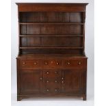 George III oak dresser and rack, circa 1800, the rack with a concave cornice above three shelves,