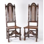 Pair of late 17th Century oak caned chairs, the tall arched rail flanked by finials above the cane