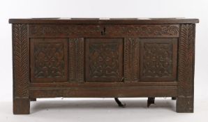 Charles II oak coffer, circa 1680, the panel top above a scrolling carved frieze and three carved