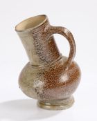 17th Century deformed salt glazed stoneware jug, the jug with a large lean to one sign from the time