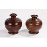 Pair of turned treen tea caddies, each with a bulbous body and a lid inside the recess of the vase