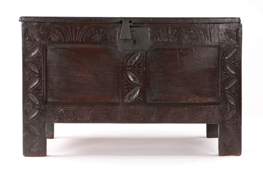 Small Charles II oak coffer, Devon, circa 1660, the rectangular top above a lunette carved frieze