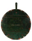 Large early 20th Century German painted serving board, the circular green painted board with