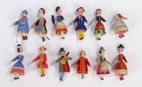 Collection of Swiss carved figures, in bright polychrome colours above the wobbling legs supported