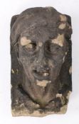 18th Century sandstone figure corbel, carved as a man with headwear and mouth slightly open, 28cm