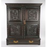 17th Century and later oak cupboard, the pediment top above two rose and thumb moulded carved