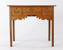 George III oak lowboy, the rectangular top above three drawers and a shaped apron on the square