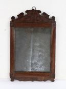 George III mahogany wall mirror, the original rectangular plate with an arched pediment above the