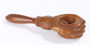 19th Century nutcracker, of a hand holding a nut and a screw thread cracker inside, 16.5cm long