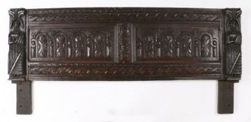 James I oak headboard, circa 1620, with two sunken panels carved with arches flanked by two