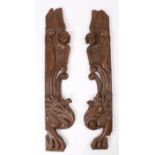 Pair of large late 17th Century carved oak architectural pilasters, with winged angles above scrolls