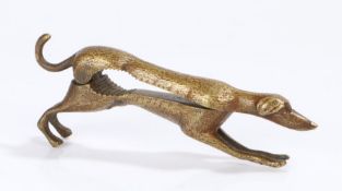 Novelty brass nutcracker, in the form of a greyhound with a hinged body, the inside of the body with