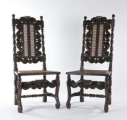 A pair of late 17th century walnut and cane side chairs, circa 1685, each back having a pair of