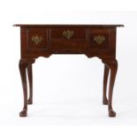 George III oak lowboy, having a twin-boarded and round front corner top, an ogee-arched apron