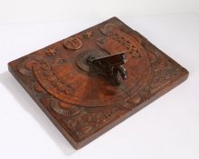 Unusual carved fruitwood sundial, with a moon and stars above signs of the Zodiac and two carved