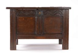 A small Charles II oak coffer, Devon, circa 1660, having a twin-panelled lid and front, and a
