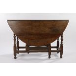 18th Century oak gate leg table, with D shaped leaves, raised on turned legs and chamfered