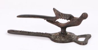 Unusual early 20th Century combination nutcracker bottle opener, with a bird with a nutcracker