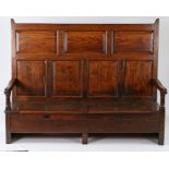 Early 18th Century oak Welsh settle, with fielded panels to the back and downswept scroll ended open