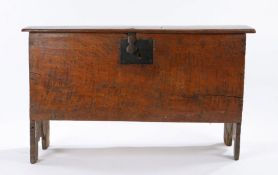 Early 17th Century oak boarded chest, West Country, the hinged lid with scalloped ends opening to