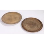 Two 19th Century treen platters, the first in oak with a rounded edge, 29cm wide, the second in