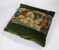 A large cushion of 17th century verdure tapestry and velvet, of foliate design in typical palette of