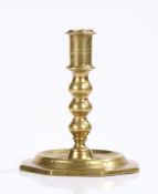 Spanish late 17th Century brass candlestick, the turned stem above a wide octagon foot, 13cm high