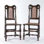 A pair of William & Mary oak and cane side chairs, circa 1690, of rare form, each with a dished,