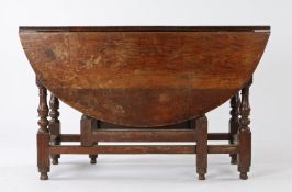 17th Century oak gateleg table, the oval drop leaf top above a single frieze drawer, raised on