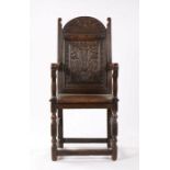 Late 17th Century English oak Wainscot chair, the arched top with a two carved aquatic beasts