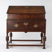 18th Century oak desk box on stand, the rectangular top above a sloping fall inclosing pigeon