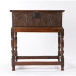 Charles I boarded oak box on later stand, circa 1640, the rectangular top above a pair of carved