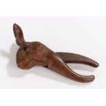 19th Century nutcracker, carved in softwood as a rabbit/hare set with dark coloured eyes, 16cm long