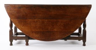 George I oak gate leg table, Welsh circa 1720, the oval drop leaf top with a single drawer to either