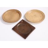 Two treen platters, to include a near pair 22cm wide and a trencher with a dished centre and a