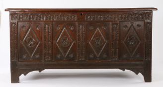 Charles I oak coffer, West Country, circa 1640, flanked by stiff leaf carved uprights raised on