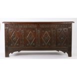 Charles I oak coffer, West Country, circa 1640, flanked by stiff leaf carved uprights raised on