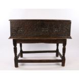 An impressive Elizbeth I/ James I large oak boarded box, circa 1600/1620, the plank top above a