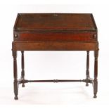 William and Mary / Queen Anne oak desk on stand, English, circa 1690 – 1710. The fall front sloped