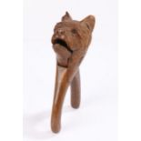 19th Century treen nutcracker, in the form of a dog set with glass eyes, 18cm long