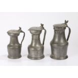 Three 18th/19th Century pewter flagons, Northern France, each with acorn finials above a hinged