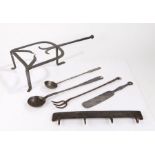 Metalwork, to include an 18th Century trivet, two ladles, a fork, a set of hooks and a spatula, (6)