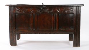 Charles I oak coffer, circa 1630, having a triple-panelled lid and front, a carved pointed-leaf, bud