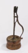 An early 19th Century English candleholder, circa 1820, North England, the wrought iron arm with